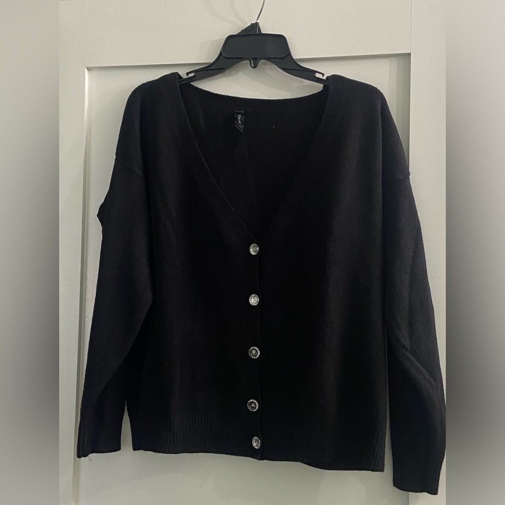 Venti6 black sweater with front buttons and star appliqué on back.